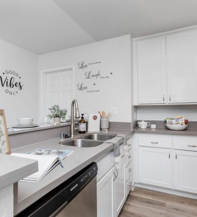 The Violet On Virgil Apartments in LA; A modern kitchen with sleek stainless steel appliances and warm wooden floors.