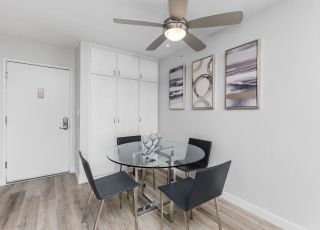 Violet On Virgil Apartments rental apartments photos; A cozy dining room with a small table and chairs, perfect for intimate gatherings.