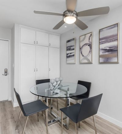 Violet On Virgil Apartments rental apartments photos; A cozy dining room with a small table and chairs, perfect for intimate gatherings.