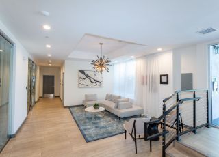 The Violet On Virgil Apartments; Virgil Avenue Los Angeles; The lobby of a building featuring a checkered floor, creating a visually striking pattern.