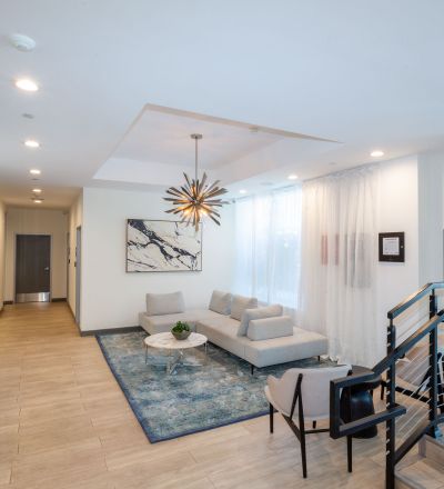 The Violet On Virgil Apartments; Virgil Avenue Los Angeles; The lobby of a building featuring a checkered floor, creating a visually striking pattern.