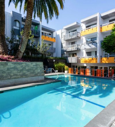 Virgil Avenue Los Angeles; A sparkling pool surrounded by lush greenery at Violet On Virgil Apartments Los Angeles.