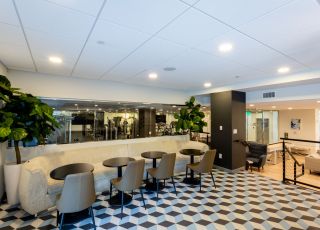 Next Apartments Los Angeles; The Violet Apartments In LA; An image of a building's lobby with a checkered floor, providing a stylish and sophisticated atmosphere.